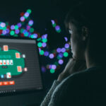 Woman playing online poker late at night, games and gambling concept